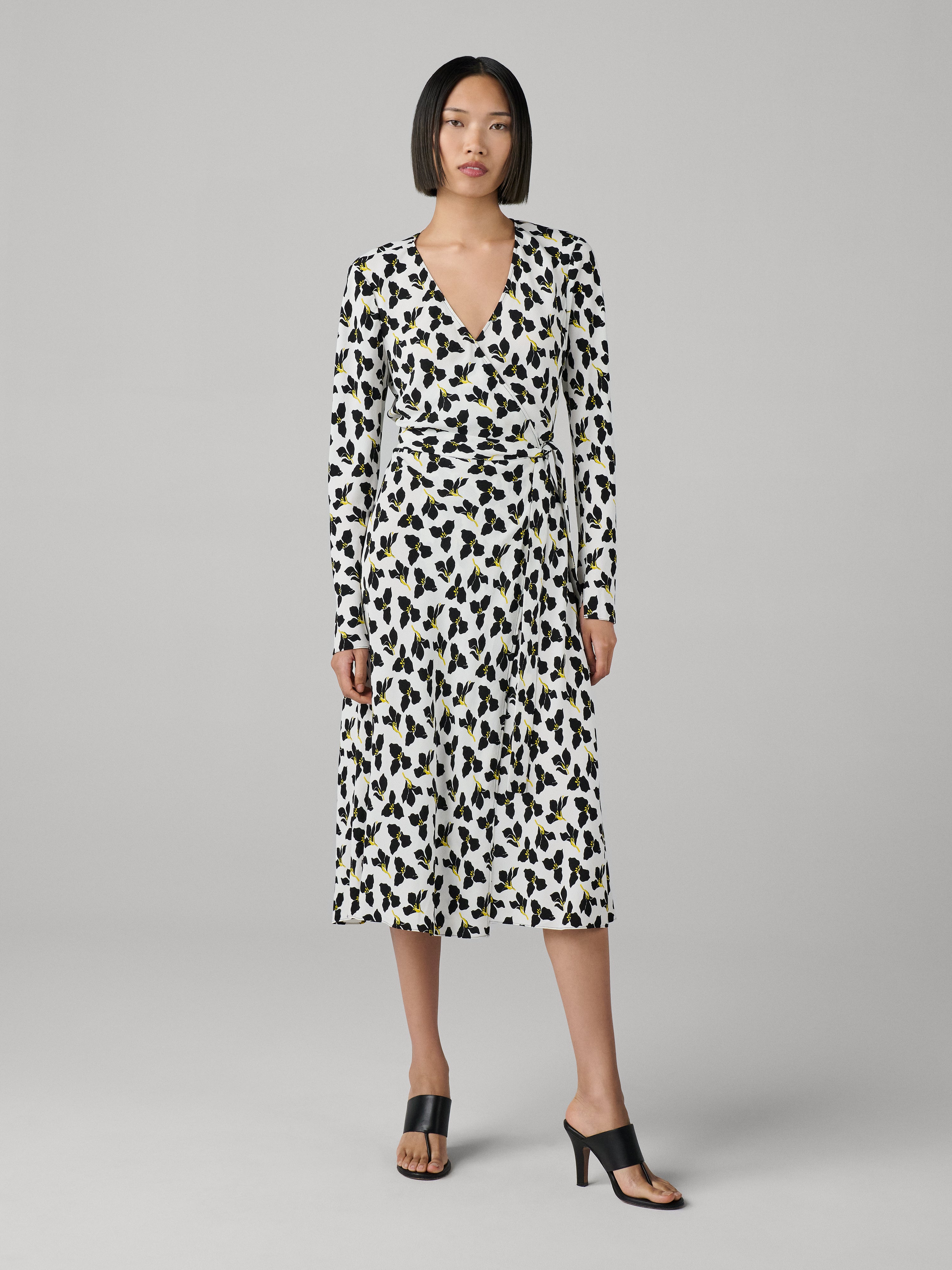 Woman wearing a leopard print dress on a gray background