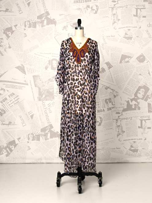 Leopard print dress on a mannequin against a newspaper background